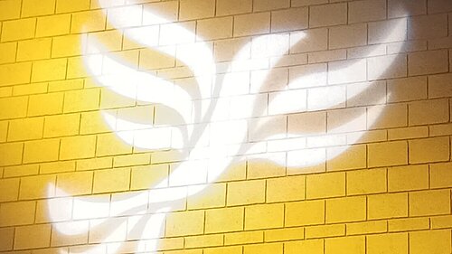 Lib Dem logo bird projected on blockwork